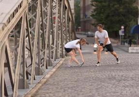 couple warming up and stretching before jogging photo