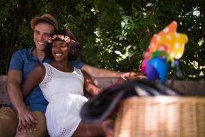 Young multiethnic couple having a bike ride in nature photo