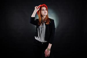 Engineer woman in orange protect helmet on studio black background. photo