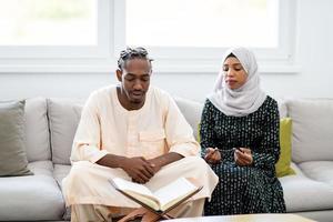 african couple at home reading quran photo