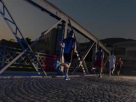 young people jogging across the bridge photo