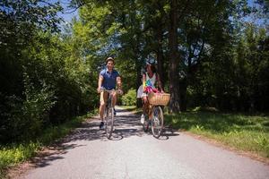 Young multiethnic couple having a bike ride in nature photo