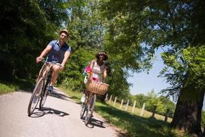 Young multiethnic couple having a bike ride in nature photo