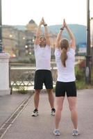 couple warming up before jogging photo