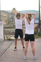 couple warming up before jogging photo