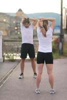 couple warming up before jogging photo