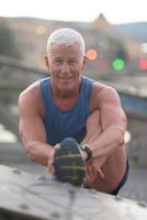 handsome man stretching before jogging photo