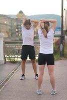 couple warming up before jogging photo