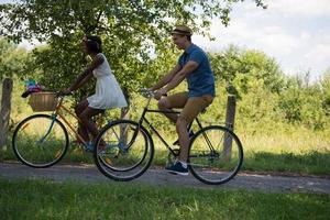 Young multiethnic couple having a bike ride in nature photo