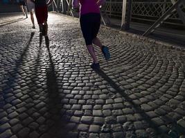 young people jogging across the bridge photo