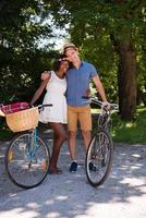 Young multiethnic couple having a bike ride in nature photo
