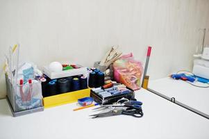 Creative fashion designer desk or workplace with sewing equipment. photo