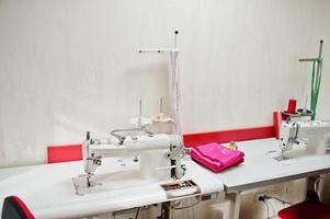 Workplace of seamstress office with sewing machine on table. photo