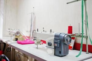 Workplace of seamstress office with sewing machine on table. photo