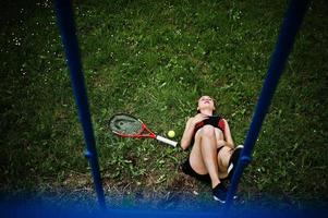 Beautiful sport woman tennis player with racket in sportswear costume. photo