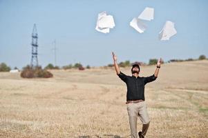 South asian agronomist farmer threw the papers into the sky at wheat field. Agriculture production concept. photo