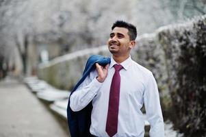 Elegant indian fashionable man model on suit posed at winter day. photo