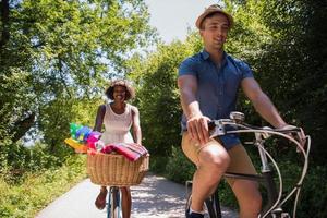 Young multiethnic couple having a bike ride in nature photo