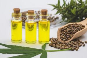 aceite de cáñamo cbd, extracto de aceite de cáñamo en botellas de vidrio, concepto de marihuana medicinal, sobre fondo blanco, pipeta de aceite cbd. foto