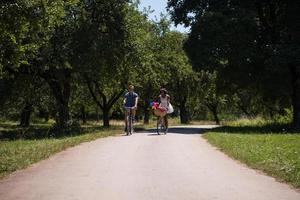 Young multiethnic couple having a bike ride in nature photo