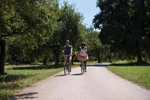 Young multiethnic couple having a bike ride in nature photo