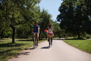 Young multiethnic couple having a bike ride in nature photo