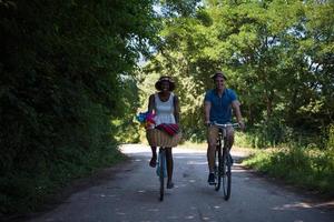 Young multiethnic couple having a bike ride in nature photo