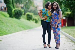 Two african american girls posed outdoor at park patch. photo