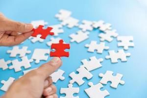 Hand of woman connecting jigsaw puzzle, Business solutions, success and strategy, Business partnership concept. photo