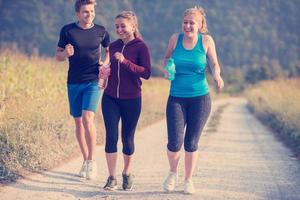 young people jogging on country road photo