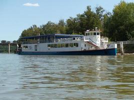 A riverboat docked by the side of the river. photo