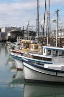 A collection of boats docked in a bay photo