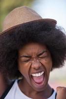 Close up portrait of a beautiful young african american woman smiling and looking up photo