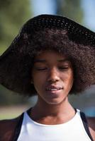 primer plano retrato de una hermosa joven afroamericana sonriendo y mirando hacia arriba foto