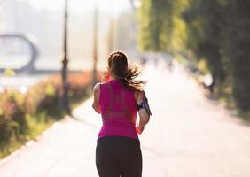 woman jogging at sunny morning photo