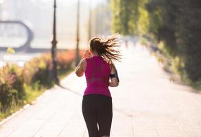 woman jogging at sunny morning photo