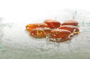 isolated wet zen stones with splashing  water drops photo