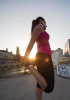 athlete woman warming up and stretching photo