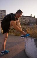 man tying running shoes laces photo