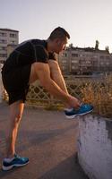 man tying running shoes laces photo