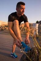 man tying running shoes laces photo