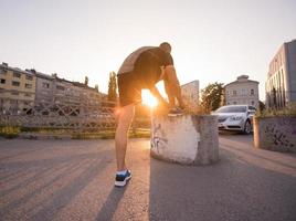 man tying running shoes laces photo