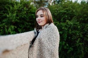 Young brunette girl on plaid having fun at evening spring day. photo