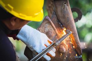 Cutting of a steel with splashes of sparks,  Metal processing with angle grinder. Sparks in metalworking. photo