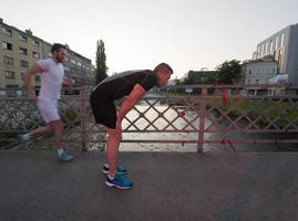 group of young people jogging across the bridge photo