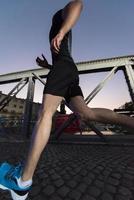 man jogging across the bridge in the city photo