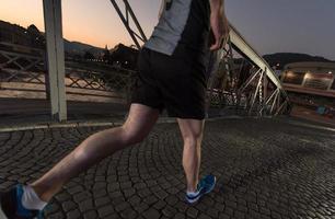 man jogging across the bridge in the city photo