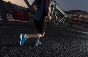 man jogging across the bridge in the city photo