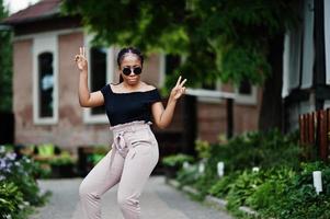 Stylish african american woman at sunglasses posed outdoor. photo