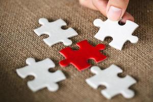 Placing missing a piece of puzzle. business concept,  pieces of wooden jigsaw are connected together isolated on white background. concept of connecting. photo